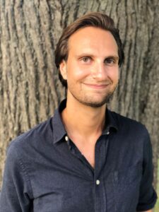 Photo of Josh Stieber, Founder of Winding Elm Psychotherapy, standing in front of a tree in Central Park, NYC